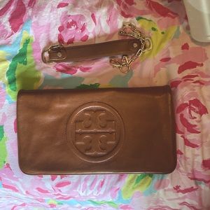 Tory Burch brown leather clutch with strap. GUC